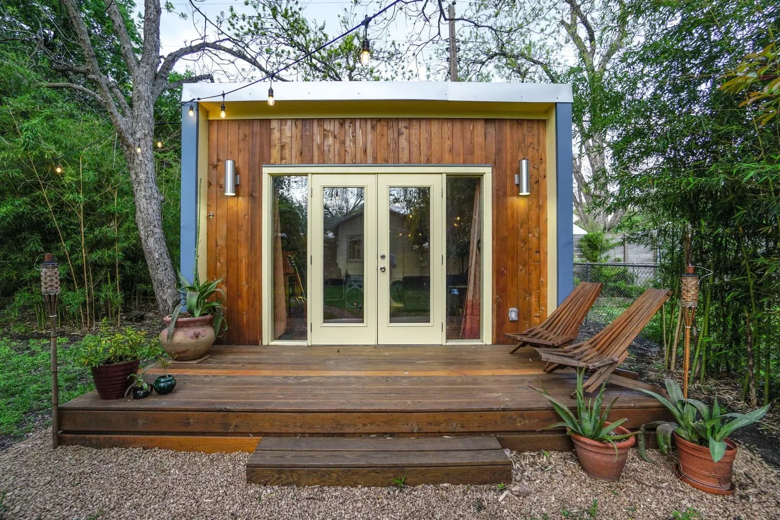 Finished Kanga 12x14 Kwik Room backyard office with cedar siding, french doors and a wood deck