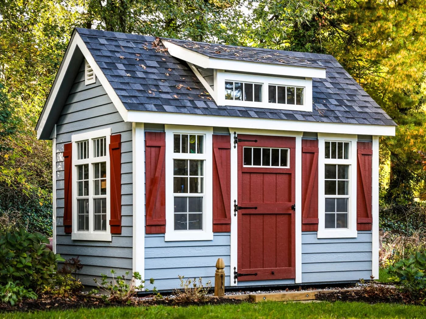 Light blue 8x12 Premier office shed with red door and white-trimmed windows