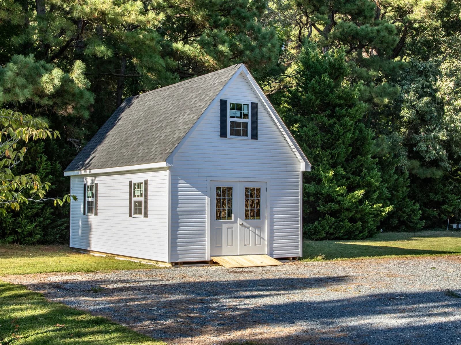 Light gray Legacy two-story shed with steep gable roof and double doors